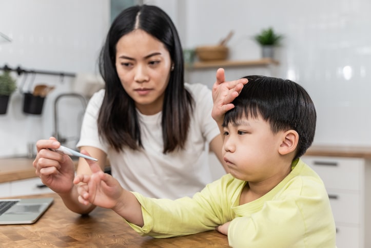 Little boy with RSV in kids and his mom