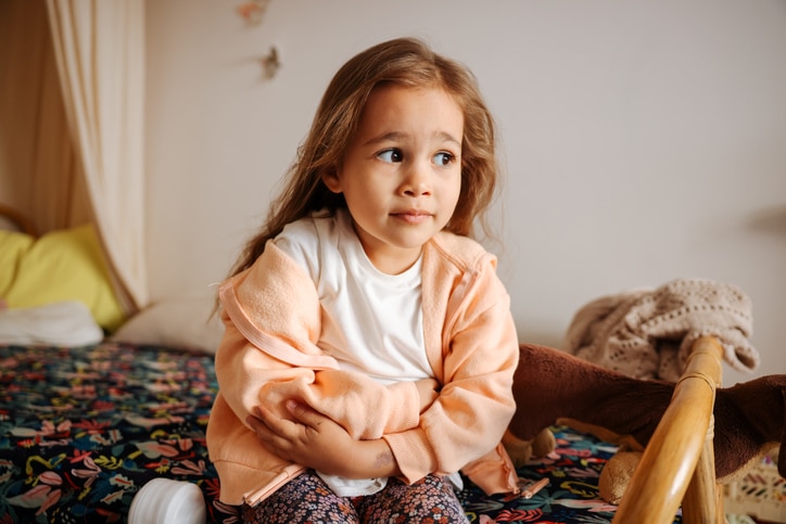 little girl with a stomach ache and treating nausea in kids