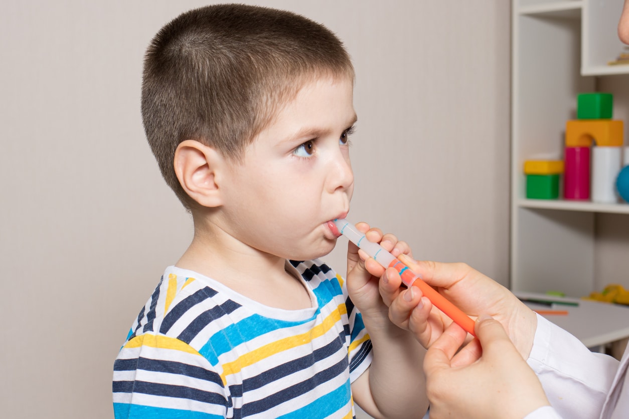 Little boy being given Ibuprofen for kids